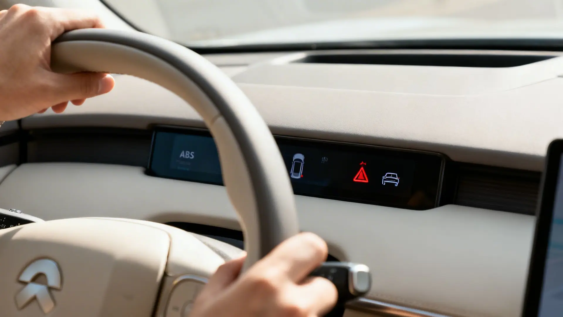 A driver's hands on a car's steering wheel, with dashboard display showing ABS and warning lights.
