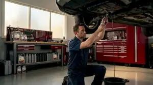 Mechanic begins oil change in clean garage