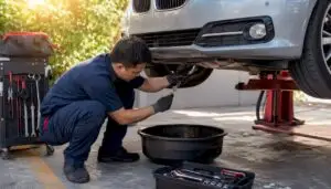 Technician changing oil on a BMW car
