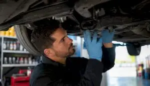 Certified technician inspecting vehicle engine