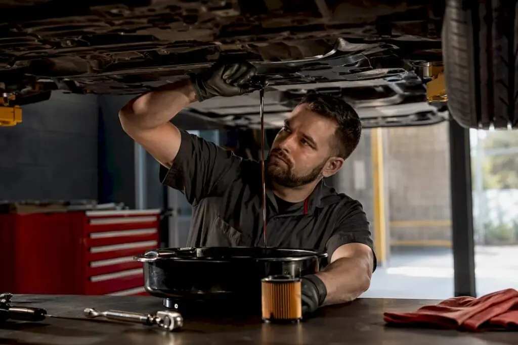 Technician performing an oil change service