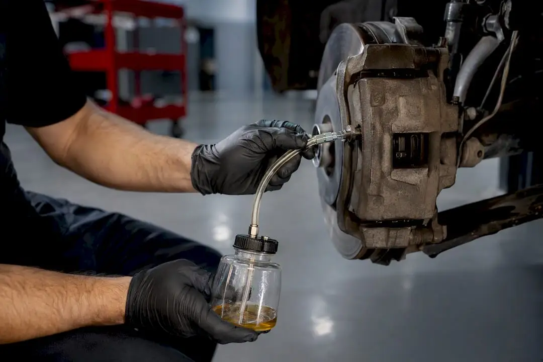 Technician performing a brake fluid flush