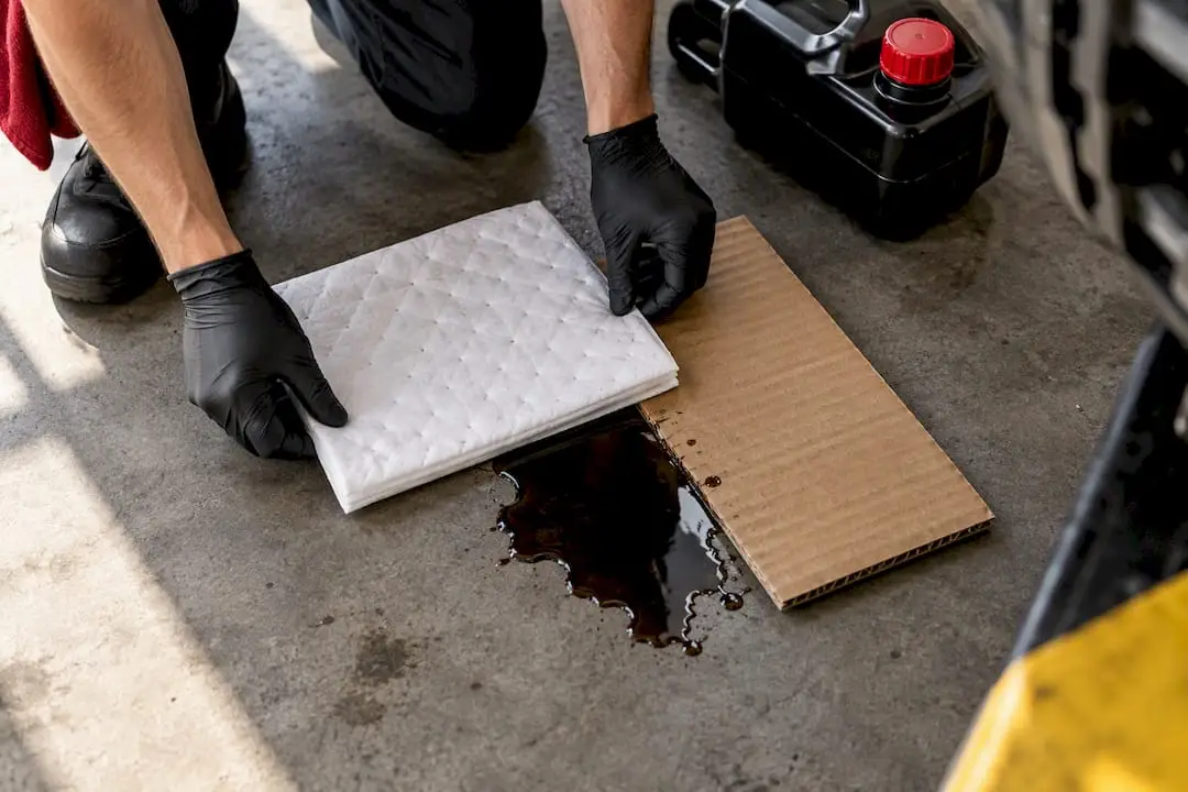 Absorbent pad containing used motor oil