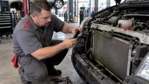 Technician photographing a radiator leak
